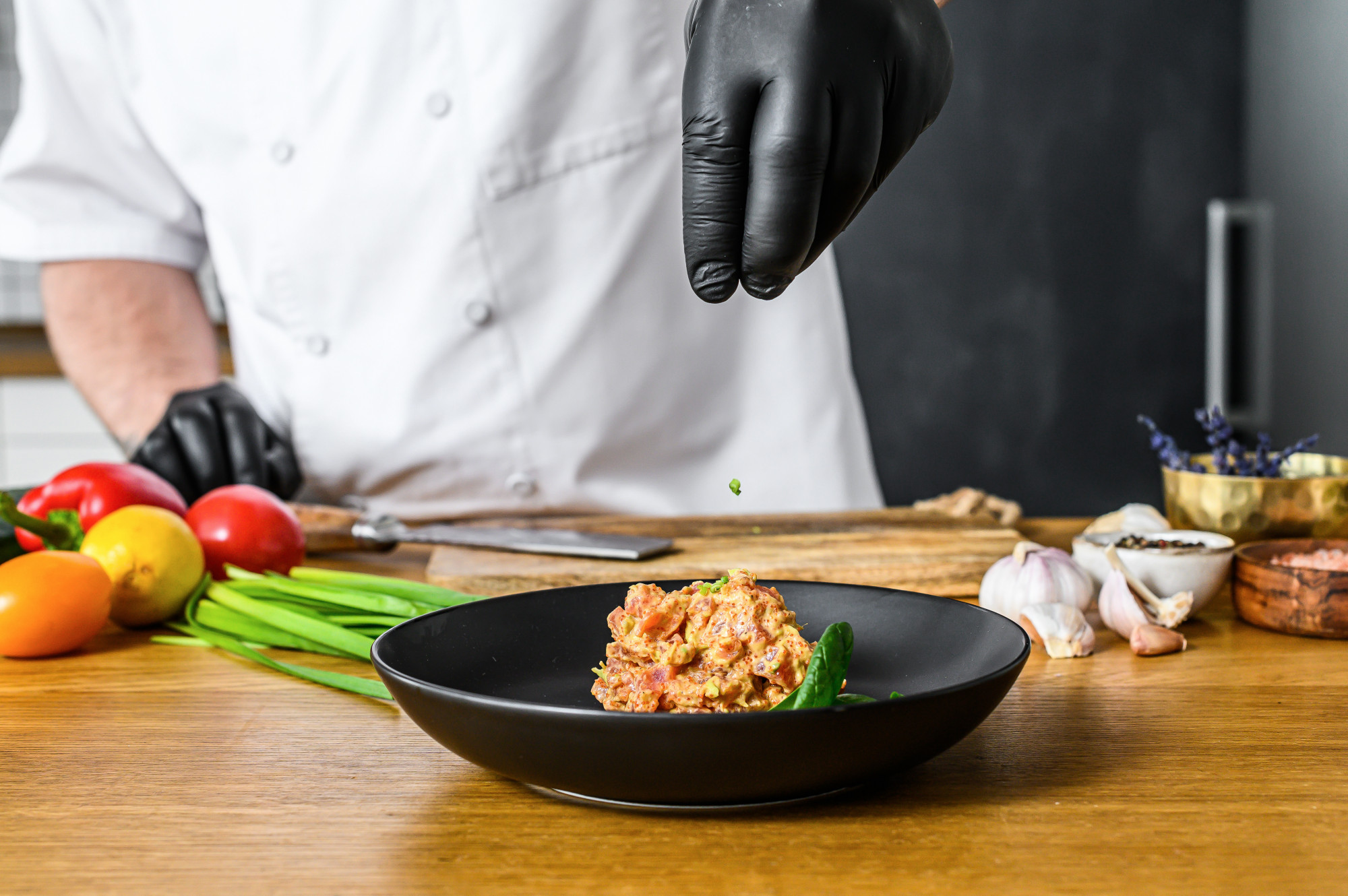 chef preparing a plated dish in a modern kitchen